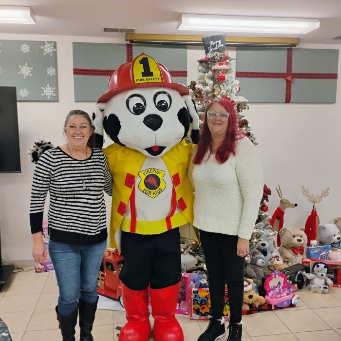 two women with mascot and tree