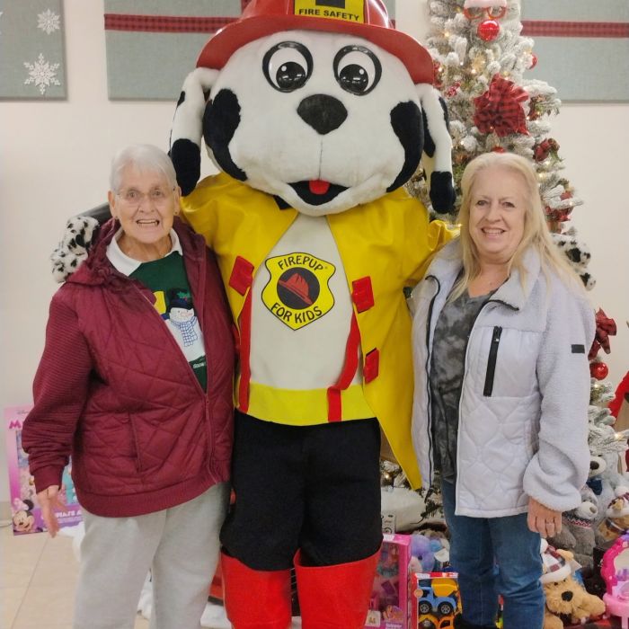 two women with mascot and christmas tree