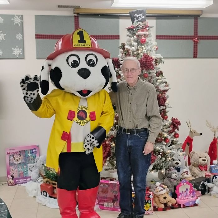 man with mascot and tree