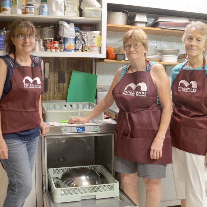 3 Milestones employees smiling at camera