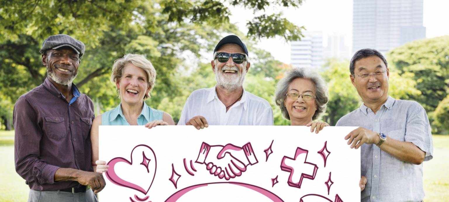 Group of people holding a sign reading 'volunteer'