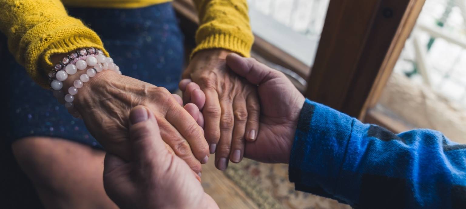 young hands holding old hands 