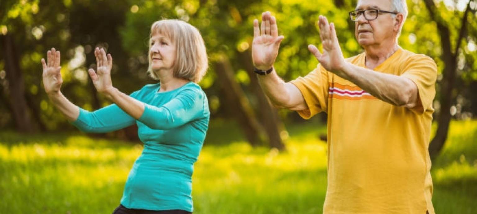 fresh fruits and veggies being cut on cutting board