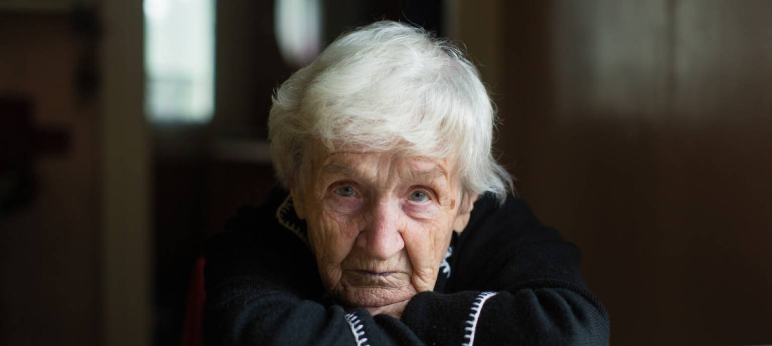 An older woman looking sad and confused