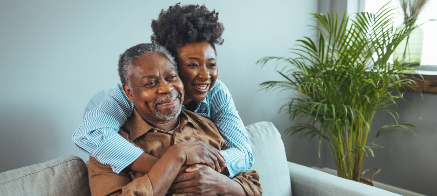 Woman sweetly hugging man from behind